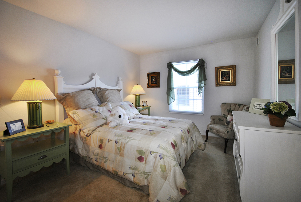 Bedroom with window in Swanhaven Manor apartment home